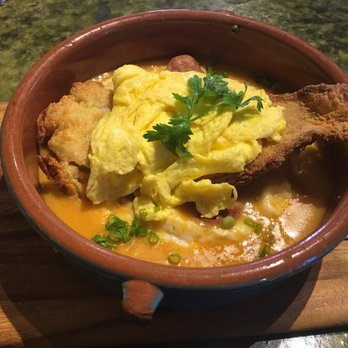 Bella's Cafe - The Bayou: A cornmeal crusted Catfish fillet with scrambled eggs and andouille grits topped with a creamy smoked paprika sauce. - Breakfast & Brunch Near Me - New Haven, Connecticut