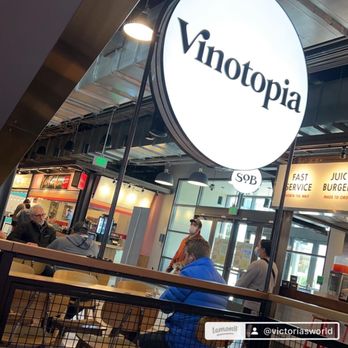 Vinotopia - a group of people sitting at tables in a restaurant - Wine Bars Near Me - Plano, Texas