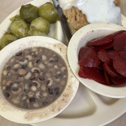 a plate of beans, pickles and bread