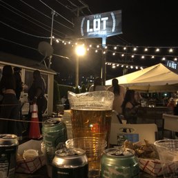 a table with a beer and cans on it a table with a beer and cans on it