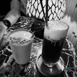 Mango lassi on the L, rum and coke float on the R Mango lassi on the L, rum and coke float on the R