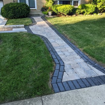 A Garden Guy - a brick walkway in front of a house - Landscaping Near Me