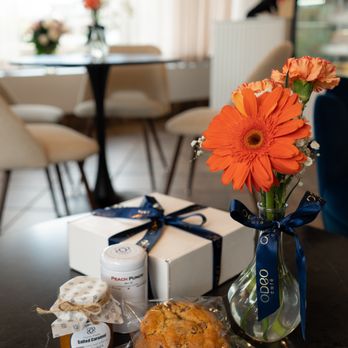 Odeo Cafe - a vase of flowers, a cookie, and a jar of jams on a table - Patisserie/Cake Shop Near Me - Algonquin, Illinois