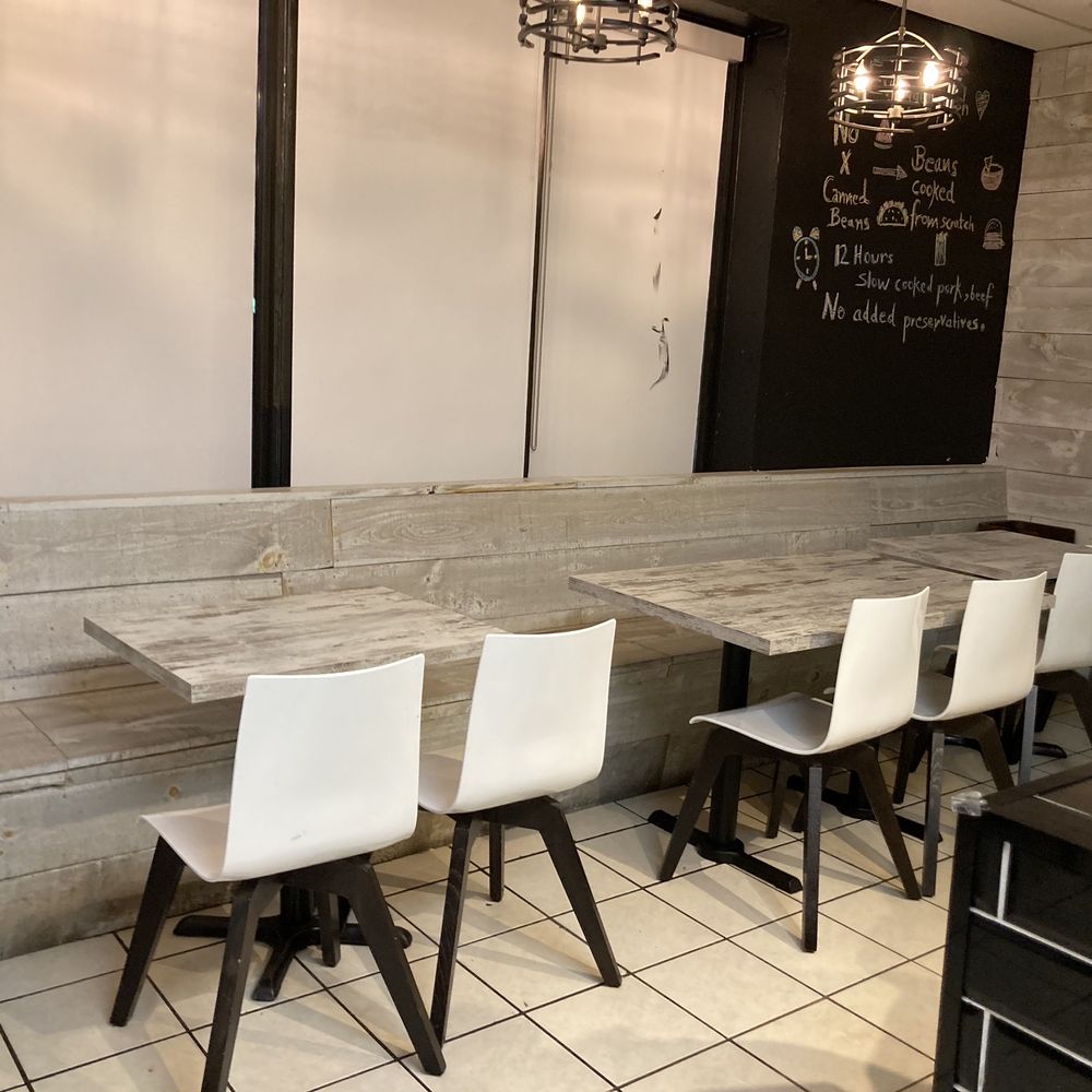 Grillies - a woman sitting at a table in a restaurant - Mexican Near Me - Markham, Ontario Grillies - a woman sitting at a table in a restaurant - Mexican Near Me - Markham, Ontario