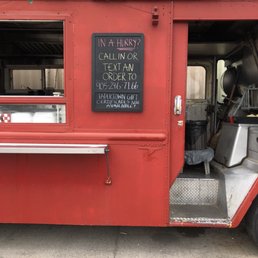 a red food truck with its door open a red food truck with its door open