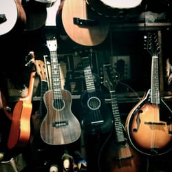 Music Inn World Instruments - A wall of guitars in the back of the shop.