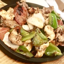 Los Manjares De Pepe - Fajitas, triple mix (shrimp, beef and chicken), served with rice and beans