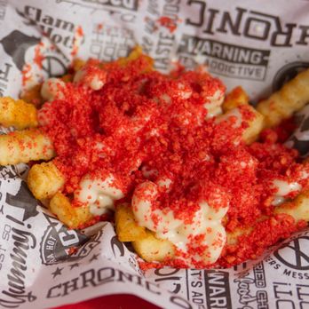 Chronic Fries - a closeup of the red sauce on top of the fries - New American Near Me - Fulshear, Texas Chronic Fries - a closeup of the red sauce on top of the fries - New American Near Me - Fulshear, Texas