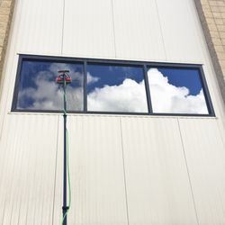 Bluebird Window Cleaning - Using the water-fed pole system to clean this commercial building in Redding.