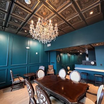 Brew House Downtown - a dining room with a chandelier - Speakeasies Near Me - Toledo, Ohio
