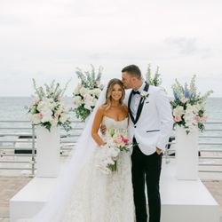 Between Flowers Design - Bride and Groom at the altar
