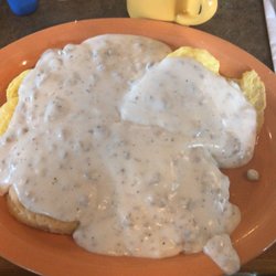 Family Tradition Restaurant - Half order of biscuits & gravy with a side of scrambled eggs underneath. Amazing! And huge!