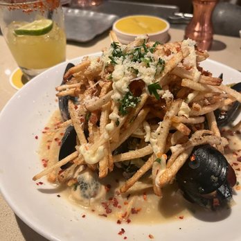 Pasta Moon - Starter- mussels topped with fries, I would order this again. Garlic sauce was great! - Italian Near Me - Half Moon Bay, California