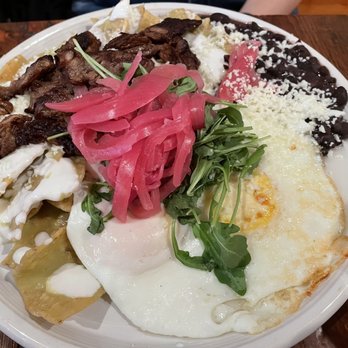 Amerikas - Chilaquiles with steak and eggs - Latin American Near Me - Oak Park, Illinois Amerikas - Chilaquiles with steak and eggs - Latin American Near Me - Oak Park, Illinois