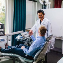 Beavercreek Dental - Oregon City dentist Dr. Kim talking to dental implants patient at Beavercreek Dental