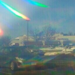 Merlins Ace Hardware - View of the ace hardware store outside looking through fireworks rainbow glasses! : )