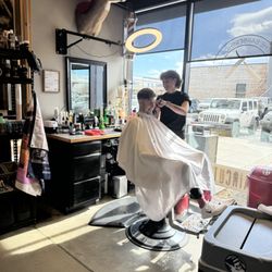 The Barbershop and Shaving Parlor - A barber working