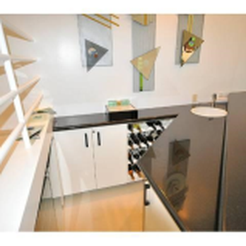 Samuels Construction - a kitchen with black countertops and white cabinets - General Contractors Near Me - Pleasant Hill, California