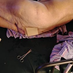 Phoenix Home Care & Hospice - Me cutting the saturated soaking wet sheet.