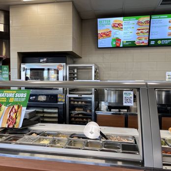 Subway - a view of a sandwich counter with a menu on the wall - Sandwiches Near Me - Victoria, Texas