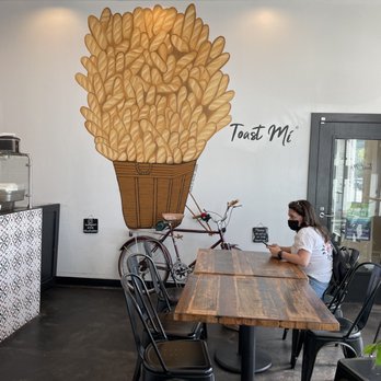 Toast Mi - a woman sitting at a table in a coffee shop - Vietnamese Near Me - Tacoma, Washington Toast Mi - a woman sitting at a table in a coffee shop - Vietnamese Near Me - Tacoma, Washington