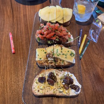 Postino Peoria - Bruschetta board (Brie/apple/fig, burrata/bacon/arugula/tomato, French onion, ricotta/dates/pistachio) - Wine Bars Near Me - Peoria, Arizona Postino Peoria - Bruschetta board (Brie/apple/fig, burrata/bacon/arugula/tomato, French onion, ricotta/dates/pistachio) - Wine Bars Near Me - Peoria, Arizona