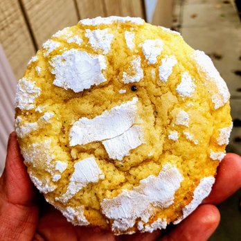 Nika's Mad Sweets - a hand holding a sugared cookie - Desserts Near Me Nika's Mad Sweets - a hand holding a sugared cookie - Desserts Near Me