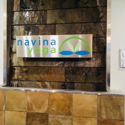 Strength & Grace Yoga - Beautiful waterfall piece displaying the Navina Yoga logo inside the room :)