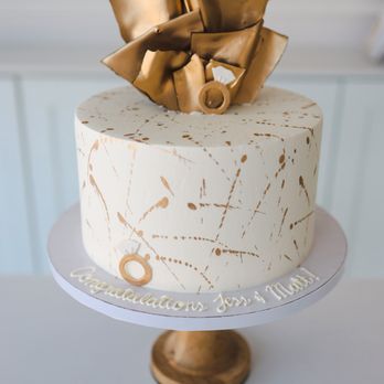 Maria Andree Boutique Bakery - a white cake with a gold bow on top - Cupcakes Near Me - Dallas, Texas Maria Andree Boutique Bakery - a white cake with a gold bow on top - Cupcakes Near Me - Dallas, Texas