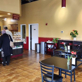 Radiant Flavors Cafe - Interior, with more seating towards the window facing 130th (5/26/24) - Cafes Near Me - Seattle, Washington