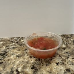 This half filled cup is expected to be shared by multiple people