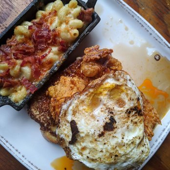 The Row - Fried chicken atop french toast topped with an egg & syrup + a side of mac - Southern Near Me - Nashville, Tennessee The Row - Fried chicken atop french toast topped with an egg & syrup + a side of mac - Southern Near Me - Nashville, Tennessee