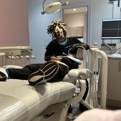 Tulane Family Dentistry - Kid getting cleaned, what you can't see are the screams on the ceiling. Pedestrians to help keep littles distracted.