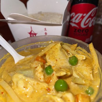 Thai Dishes - Yellow curry with chicken med heat. You can ask for a hot curry as well. Sticky rice in the back - Thai Near Me - Redondo Beach, California