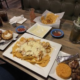 Shredded chicken nachos, carnitas, beans and rice and chips and salsa.