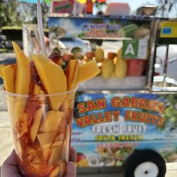 Mango cup with Chamoy drizzle, Tajin and lime.