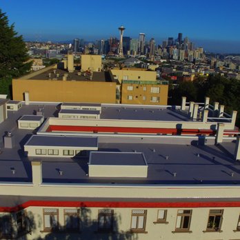 Three Tree Roofing - The historic Chelsea Apartment building, built in 1906. Multiple layer tear off, custom taper system and TPO membrane. - Roofing Near Me - Kent, Washington Three Tree Roofing - The historic Chelsea Apartment building, built in 1906. Multiple layer tear off, custom taper system and TPO membrane. - Roofing Near Me - Kent, Washington