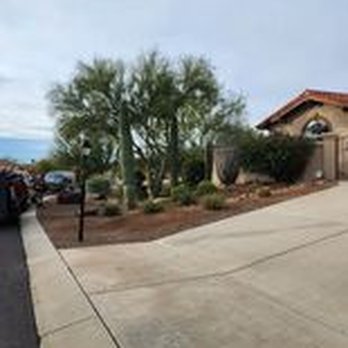 Colossal Landscaping - a driveway in front of a house - Landscaping Near Me