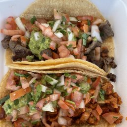 two tacos in a styrofoam container two tacos in a styrofoam container