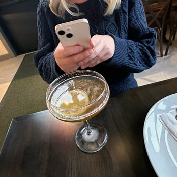Farnsworth Cocktail Bar - a woman looking at her phone - Seafood Near Me - Waterville, Ohio