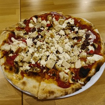 Cafe Adel - a pizza on a plate on a table - Mediterranean Near Me - Houston, Texas