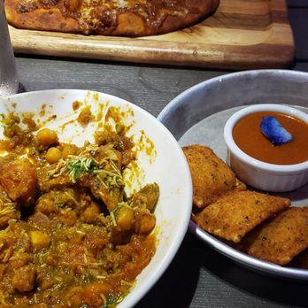 Curry Up Now - Half eaten deconstructed samosa, fried ravioli and naughty naan in the back - Indian Near Me - Decatur, Georgia