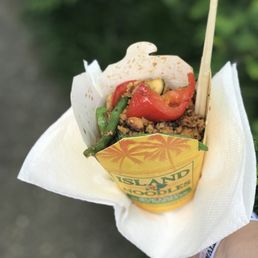 a hand holding a wrap of food a hand holding a wrap of food