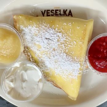Veselka - Blintz with applesauce, sour cream and raspberry coulis. - Ukrainian Near Me - New York, New York Veselka - Blintz with applesauce, sour cream and raspberry coulis. - Ukrainian Near Me - New York, New York