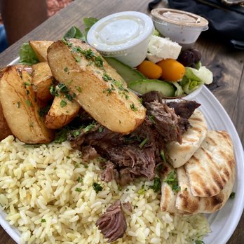Hellenic - Braised Lamb Feast- Lamb, yellow rice, salad, herb potatoes, pita, and tzatziki sauce. - Greek Near Me - Coral Springs, Florida Hellenic - Braised Lamb Feast- Lamb, yellow rice, salad, herb potatoes, pita, and tzatziki sauce. - Greek Near Me - Coral Springs, Florida