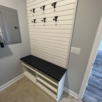 Innovative Spaces - Laundry room peg board and bench with shoe shelves underneath - Home Organization Near Me - Granger, Indiana