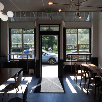 Revolutions Coffee - two people sitting at tables in a coffee shop - Coffee & Tea Near Me - Seattle, Washington