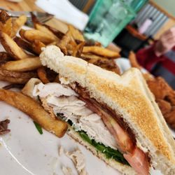 Ellie’s Place - Turkey club with 2 slices of bread instead of 3 (half eaten)