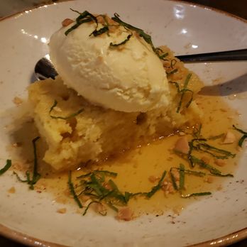 Vasili's - Pineapple revani ($12): semolina cake soaked in syrup, almonds, mint, vanilla-ginger ice cream - Mediterranean Near Me - Naperville, Illinois Vasili's - Pineapple revani ($12): semolina cake soaked in syrup, almonds, mint, vanilla-ginger ice cream - Mediterranean Near Me - Naperville, Illinois