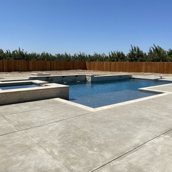 BluRock Pool Company - Swimming pool with raised wall, raised spa, diving board, and travertine coping - Pool & Hot Tub Service Near Me BluRock Pool Company - Swimming pool with raised wall, raised spa, diving board, and travertine coping - Pool & Hot Tub Service Near Me